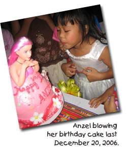 Anzel blowing her birthday cake