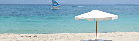 Beach umbrella and sailboat - Boracay, Philippines
