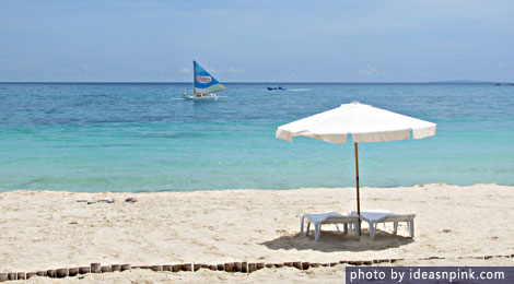 Beach umbrella and sailboat - Boracay, Philippines