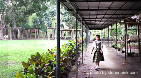A student walking along the hallway at St. Francis of Assisi School of Silay City